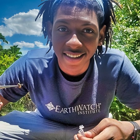 A young man collecting bees for scientific research in Costa Rica.