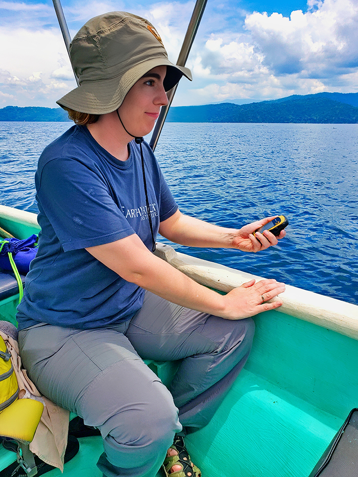 A person watching the ocean inside a small boat for whale research